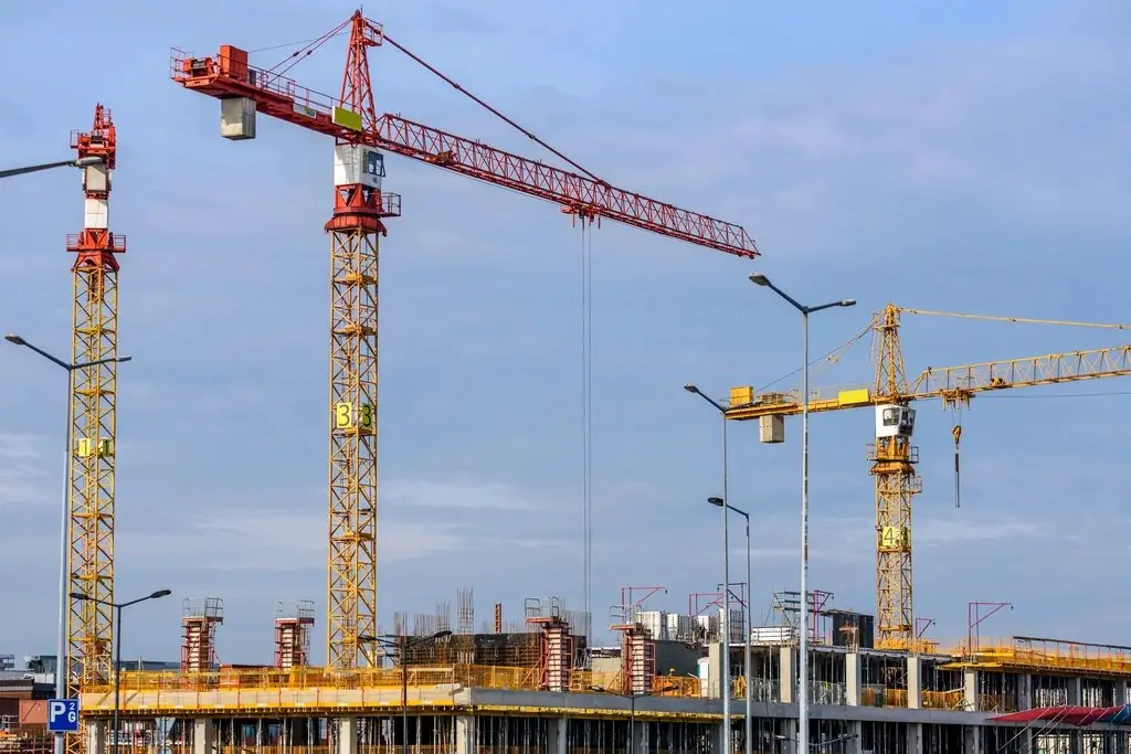 Construction cranes at a building site, representing construction finance and inventory funding