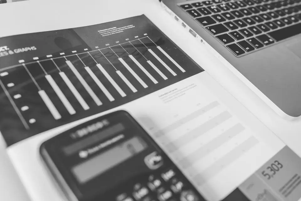 Financial charts and a calculator on a desk, representing structured debt analysis